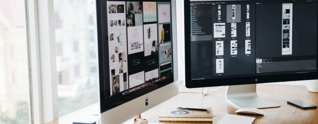 Silver Imac on Top of Brown Wooden Table